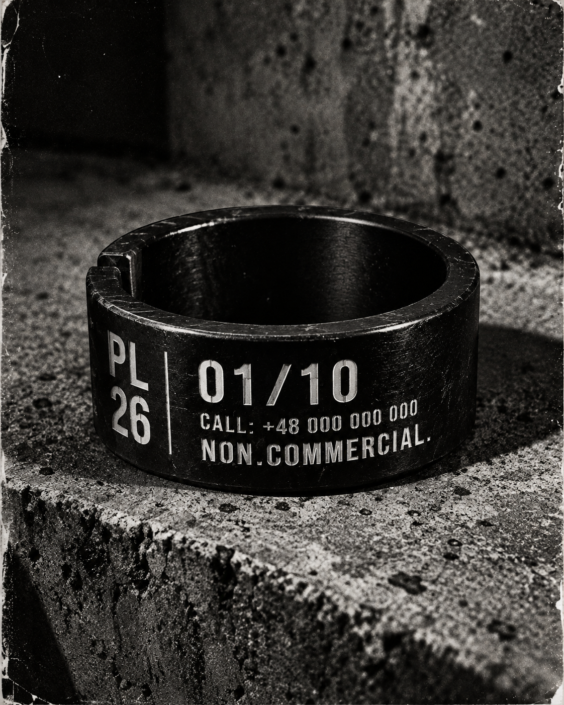Black NON.COMMERCIAL. ring on raw concrete
